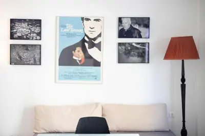 a living room with a couch and pictures on the wall at Renovated 4 Bdr House near Acropolis - New Beds, Terrace & Green Yard in Athens