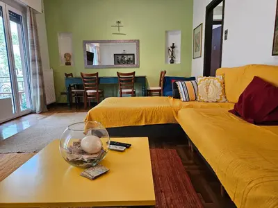a living room with a couch and a table at 3 bedder condo in Ilisia, Megaro Mousikis in Athens