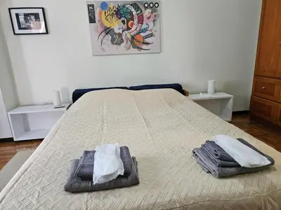a bedroom with a bed with two towels on it at 3 bedder condo in Ilisia, Megaro Mousikis in Athens