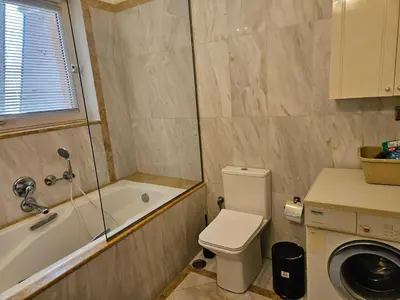 a bathroom with a tub and a toilet and a sink at 3 bedder condo in Ilisia, Megaro Mousikis in Athens