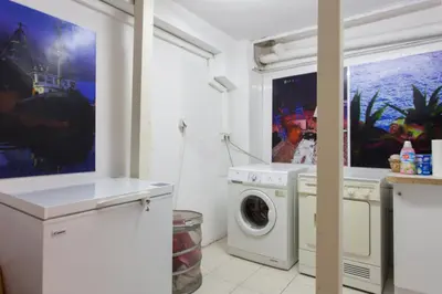 a white laundry room with a washer and dryer at Psyri Neoclassical House Yard Free Parking in Athens
