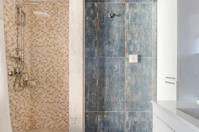 a shower with a glass door in a bathroom at Explore Nightlife Near an Apartment With an Acropolis View in Athens