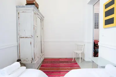 a room with an old cabinet and a red rug at Neoclassical House at Metro Station Attiki in Athens