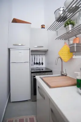 a kitchen with a white refrigerator and a sink at Neoclassical House at Metro Station Attiki in Athens