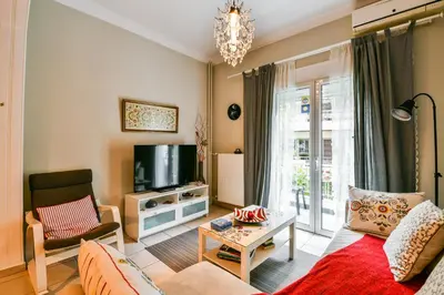 a living room with a couch and a tv at Star Acropolis Apartment in Athens