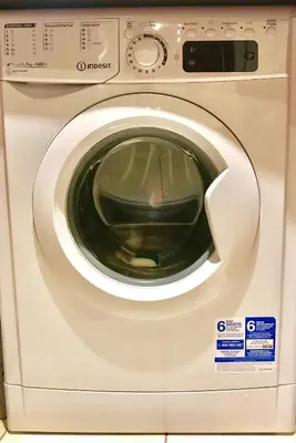 a white washing machine sitting in a room at Star Acropolis Apartment in Athens