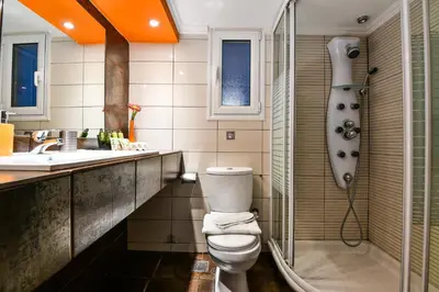 a bathroom with a toilet and a shower and a sink at Star Acropolis Apartment in Athens