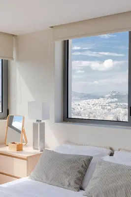 a bedroom with two beds and a large window at GB Athens View Luxury Suite in Athens