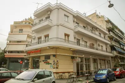 a tall building with cars parked in front of it at Mairas house collection in Athens