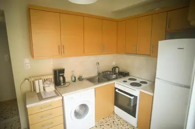 a kitchen with a white refrigerator and a washer at Mairas house collection in Athens