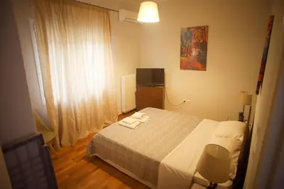 a bedroom with a bed with two towels on it at Mairas house collection in Athens