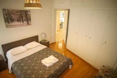 a bedroom with a bed with two towels on it at Mairas house collection in Athens