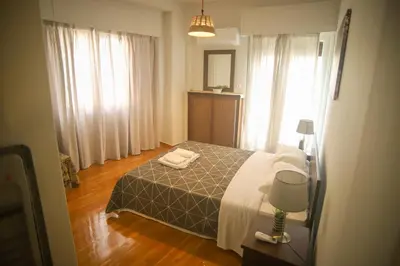 a bedroom with a bed and a window at Mairas house collection in Athens