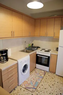a kitchen with a washing machine and a sink at Mairas house collection in Athens