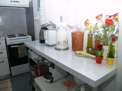 a kitchen counter with flowers and appliances on it at Newly Renovated Apt in Kolonaki in Athens