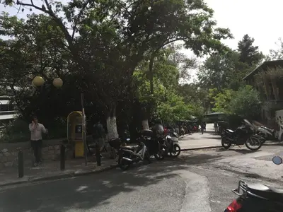 a group of motorcycles parked on the side of a street at Newly Renovated Apt in Kolonaki in Athens