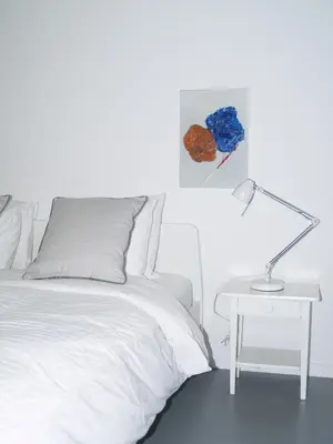 a bedroom with a bed and a table with a lamp at Newly Renovated Apt in Kolonaki in Athens