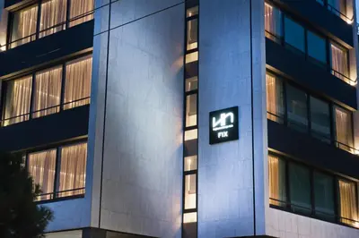 a building with a sign on the side of it at NLH FIX | Neighborhood Lifestyle Hotels in Athens