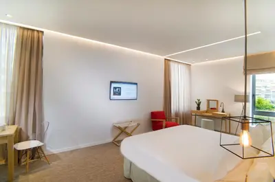a hotel room with a large bed and a window at NLH FIX | Neighborhood Lifestyle Hotels in Athens
