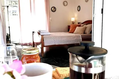 a living room with a bed and a mirror at Acropolis Area Flat with Parthenon Views in Athens