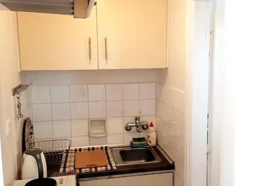 a small kitchen with a sink and a counter at Acropolis Area Flat with Parthenon Views in Athens