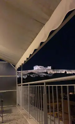 a view of a bridge from a balcony at night at Acropolis Area Flat with Parthenon Views in Athens