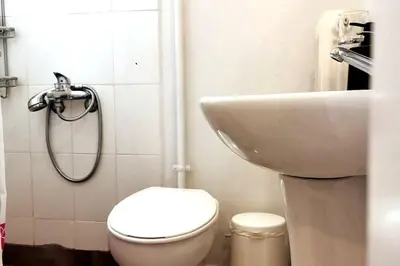 a bathroom with a toilet and a sink at Acropolis Area Flat with Parthenon Views in Athens