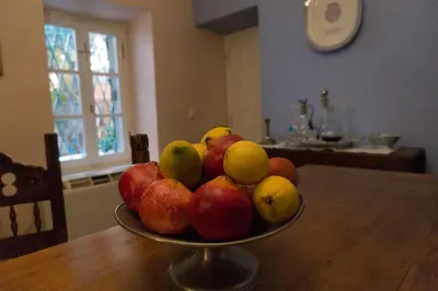 a bowl of apples and pears on a wooden table at Acropolis Villa in Plaka in Athens