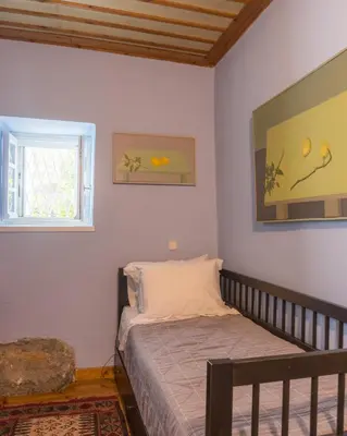 a small bedroom with a bed and a window at Acropolis Villa in Plaka in Athens