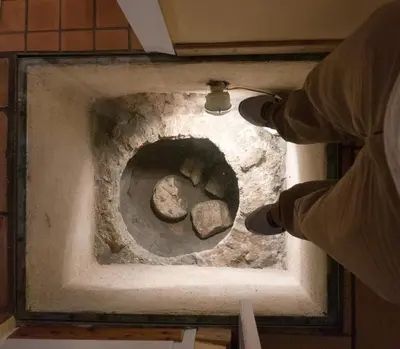 a person standing in front of a pizza oven at Acropolis Villa in Plaka in Athens