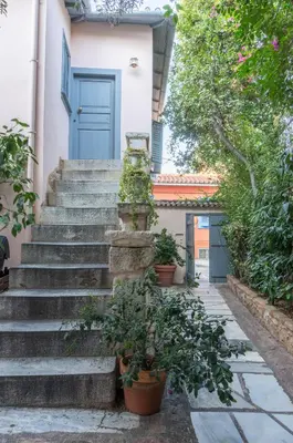 a set of stairs with a blue door at Acropolis Villa in Plaka in Athens