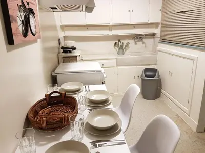 a kitchen with a table with white dishes on it at Errathens Apartments - Athens Center in Athens