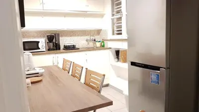 a kitchen with a wooden table and a refrigerator at Errathens Apartments - Athens Center in Athens