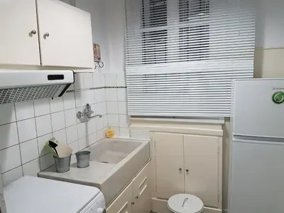 a small kitchen with a sink and a refrigerator at Errathens Apartments - Athens Center in Athens