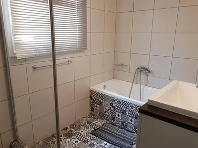 a bathroom with a bath tub and a sink at Errathens Apartments - Athens Center in Athens