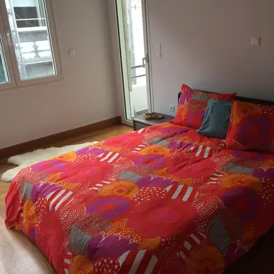 a bedroom with a bed with a colorful comforter at Lux Kolonaki Apartment in Athens