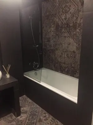 a bathroom with a bath tub and a shower at Lux Kolonaki Apartment in Athens