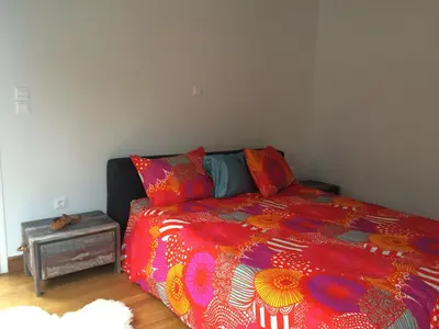 a bedroom with a bed with a colorful comforter at Lux Kolonaki Apartment in Athens