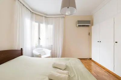 a bedroom with a bed with two towels on it at Irodotou Grand Apartment in Athens