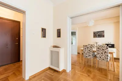 a kitchen and dining room with a table and chairs at Irodotou Grand Apartment in Athens