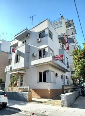 a white building with a sign in front of it at Hotel Korydallos in Piraeus