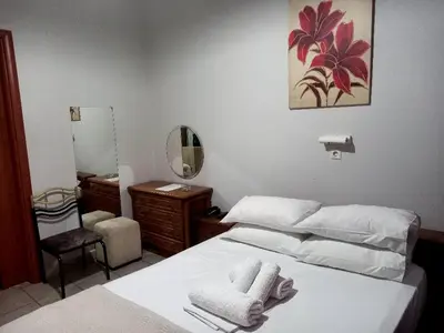 a bedroom with a white bed and a mirror at Hotel Korydallos in Piraeus