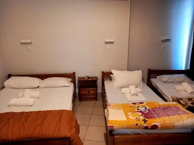 two twin beds in a room with at Hotel Korydallos in Piraeus