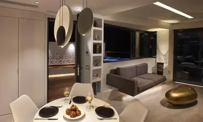 a living room with a table and chairs and a couch at Athens Avaton Suites in Athens