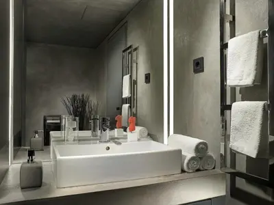 a bathroom with a white sink and a mirror at Athens Avaton Suites in Athens