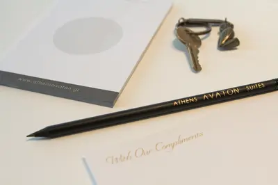 a pen and a pair of glasses on a piece of paper at Athens Avaton Suites in Athens