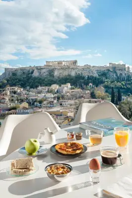 a table with food on it with a view ofhens at Athens Avaton Suites in Athens