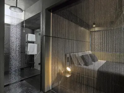 a bathroom with a shower and a glass wall at Athens Avaton Suites in Athens