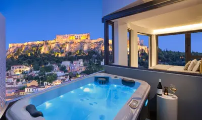 a bath tub with a view of the mountain at Athens Avaton Suites in Athens