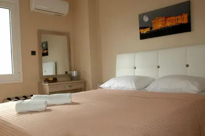 a bedroom with a bed with two towels on it at Gazi Divine Apartment in Athens